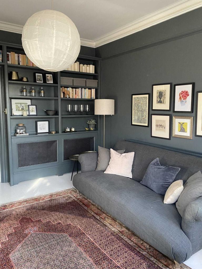 Built-in shelving painted deep grey in a living room